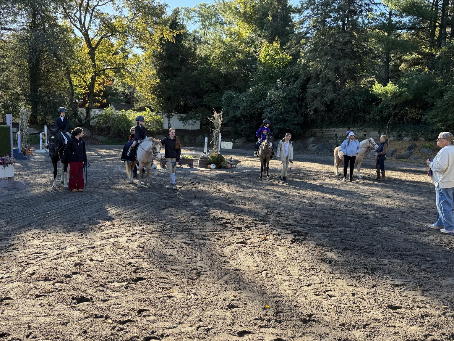 Riders and their helpers lined up together in the autumn show ring