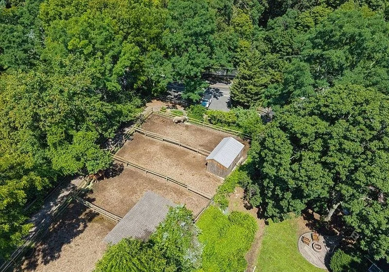 Aerial view of the full two-acre property, barn, and arena